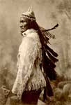 Geronimo: Portrait of Geronimo Wearing Buckskin Jacket and Cap with Feathers