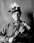 Iroquois Tribe: Portrait of Chief Gadj Nonda He, Called Robert David, i Partial Native Dress with Headdress and Ornaments and holding Pipe Tomahawk - 1901